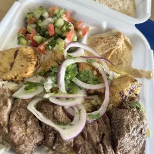 Mixed plate with  beef and chicken kebabs, house salad, and hummus.