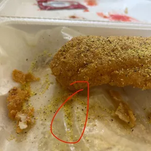 Faux designer catfish with a side of hair after being unsealed with plastic wrap and a bag of