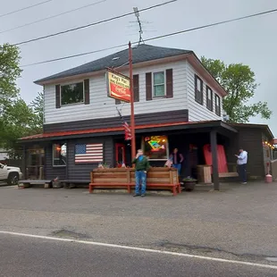two people standing in front of a restaurant