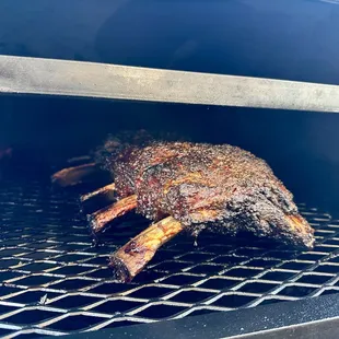 a rack of meat cooking on a grill