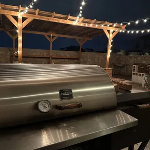 a bbq with lights strung over it