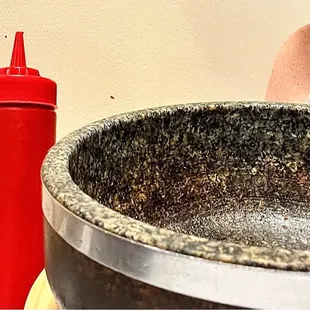 Empty stone bowl w/magical sauce (no-that's NOT ketsup in the bottle)