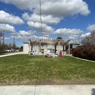 Outdoor event space with pergola backdrop
