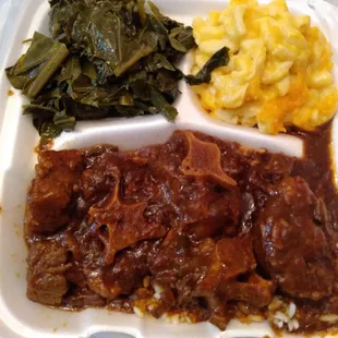 Oxtails over rice, Mac n cheese and greens.