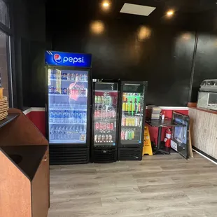 a view of a refridgerator and beverage coolers