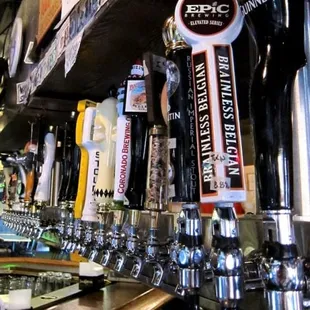 a row of beer taps on a bar