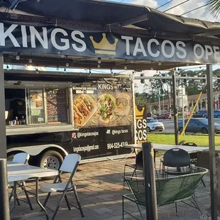 a food truck with tables and chairs