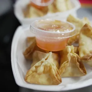 a plate of dumplings with dipping sauce