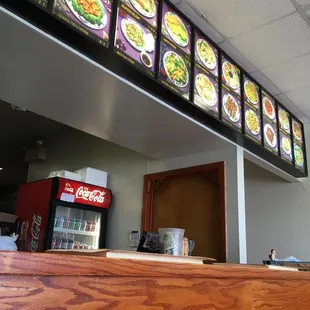 menus on the wall above the counter