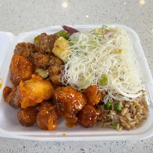 chicken, rice, and vegetables in a styrofoam container