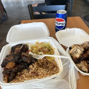 Oxtail , jerk chicken , cabbage , and rice