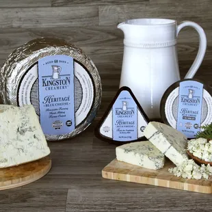 a variety of cheeses on a cutting board