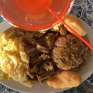 Curry Goat, festival, steamed vegetables with rice and beans.  Topped by a strawberry margarita