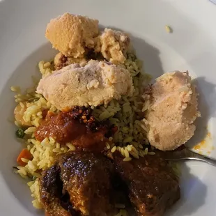 Fried rice, moi moi and goat meat