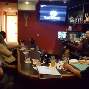 a group of people sitting at a bar