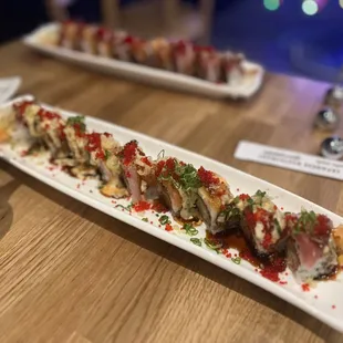 a long rectangular platter of sushi