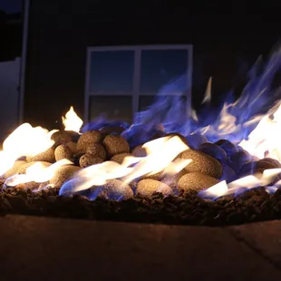 A closeup shot of lava rocks in a firepit.