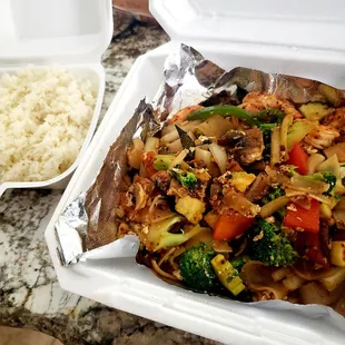 a container of rice and a container of chicken