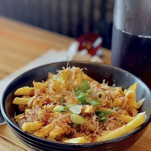 a bowl of noodles and a glass of wine