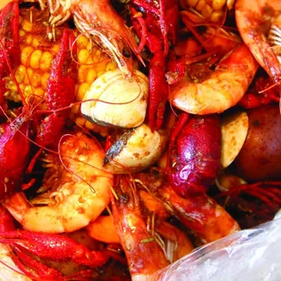 a close up of a bowl of craws and potatoes