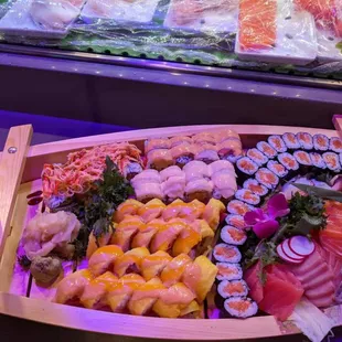 a display of sushi and rolls
