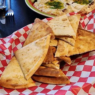 a plate of pita chips and a plate of salad