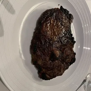 a steak on a white plate