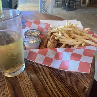 a basket of fries and a glass of beer