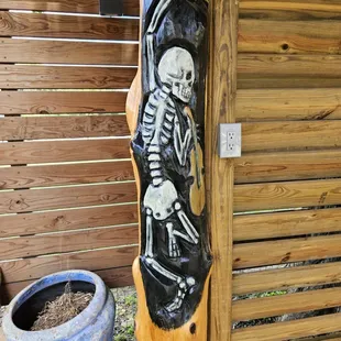 a skeleton hanging on a wooden pole