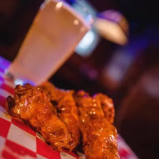 a plate of chicken wings and a drink