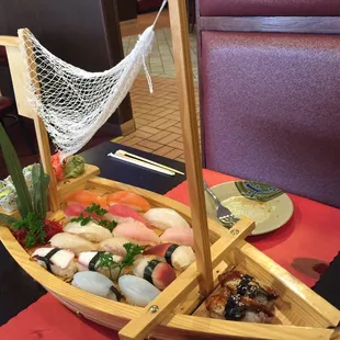 a wooden boat filled with sushi