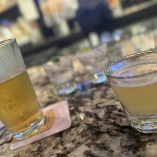 two glasses of beer on a counter