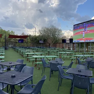 Outside seating area with big screen.