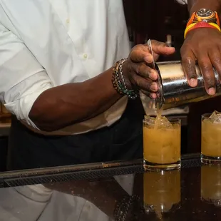 a bartender pouring a drink