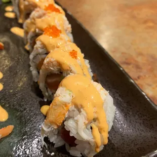 Phoenix Roll - fresh salmon, tuna, cucumber roll topped with real crab meat, spicy mayo and tobiko