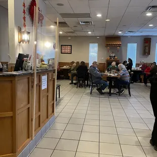 people sitting at tables in a restaurant