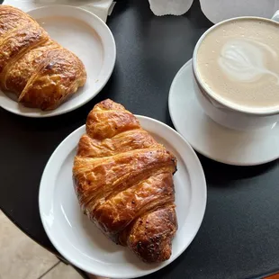 Pair of breakfast croissants (turkey and herbs to the left, ham and cheddar at the middle) plus a mocha