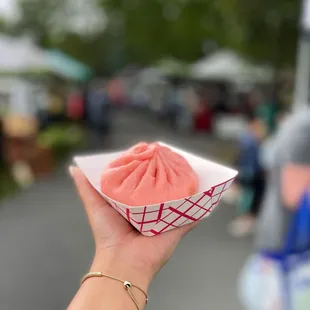 a person holding a cupcake