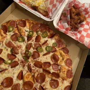 Half pepperoni and Half pepperoni and jalapeño family size pizza. Hot wings and cheesy garlic bread