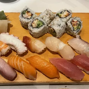 a variety of sushi on a wooden board