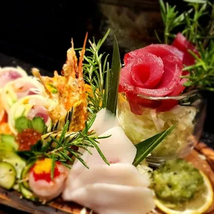 a platter of sushi and vegetables