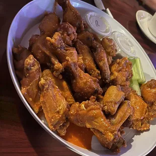 a platter of wings and celery