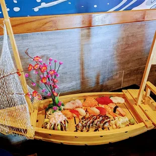 a wooden boat with sushi on it