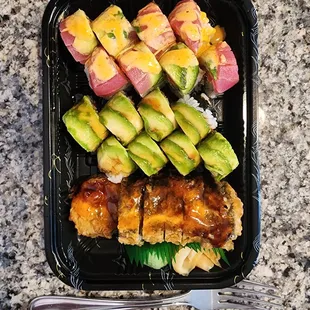 a tray of sushi and avocado