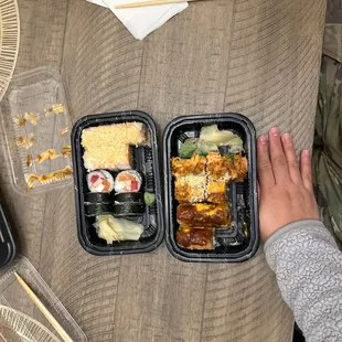 a person&apos;s hand holding a plastic container of food
