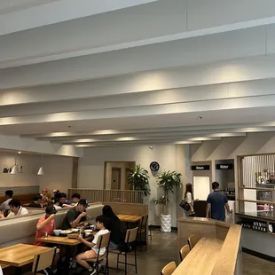 people sitting at tables in a restaurant