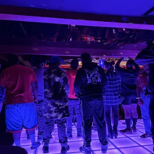 a group of people standing on a dance floor