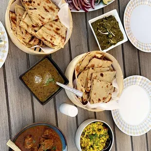 a variety of dishes on a wooden table