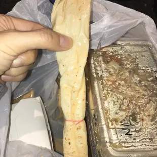 a hand holding a piece of bread