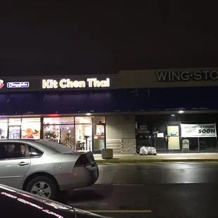 a car parked in front of a restaurant